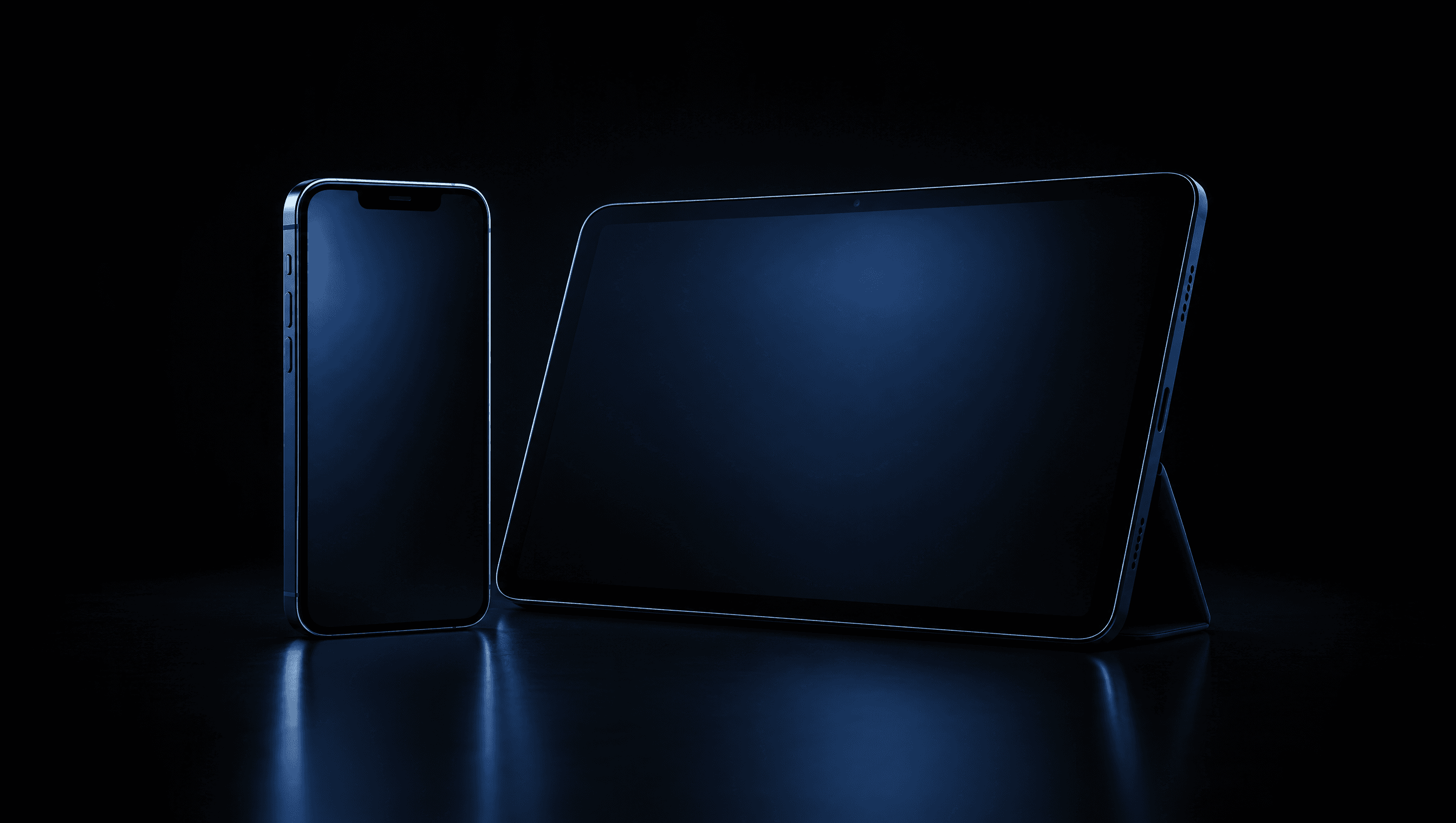 A phone and a tablet standing on a dark surface, screens glowing faintly